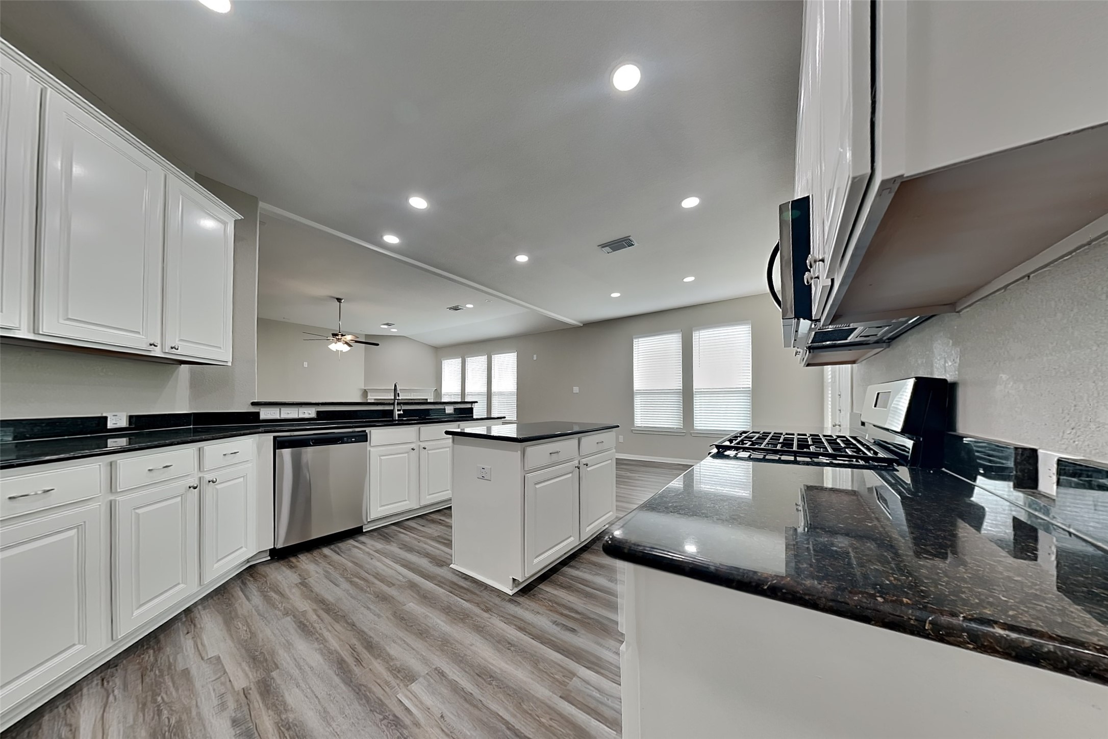 9435 Edgeloch Drive Spring, TX 77379 - Photo 5 of 18 a kitchen with stainless steel appliances granite countertop a sink a stove and a wooden floors