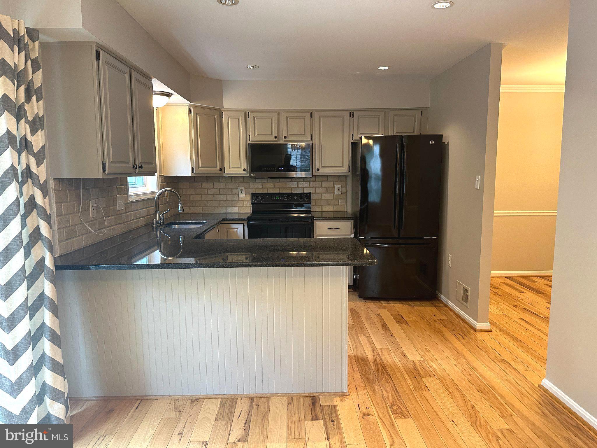 11928 Sentinel Point Court Reston, VA 20191 - Photo 9 of 23 Modern kitchen with sleek finishes.