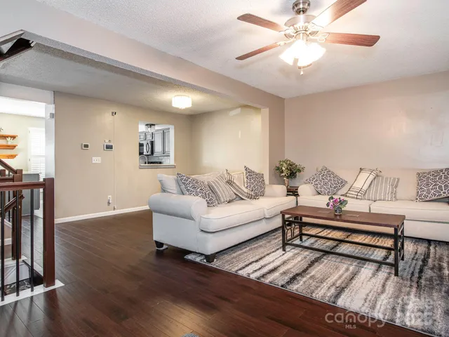 a living room with furniture and a wooden floor