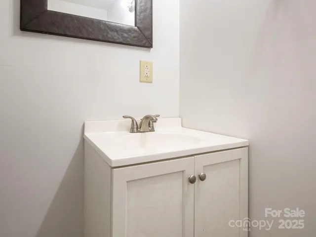 a utility room with a sink a mirror and vanity