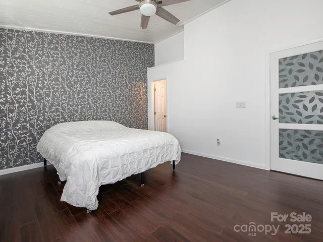 a large bed sitting in a room next to a window