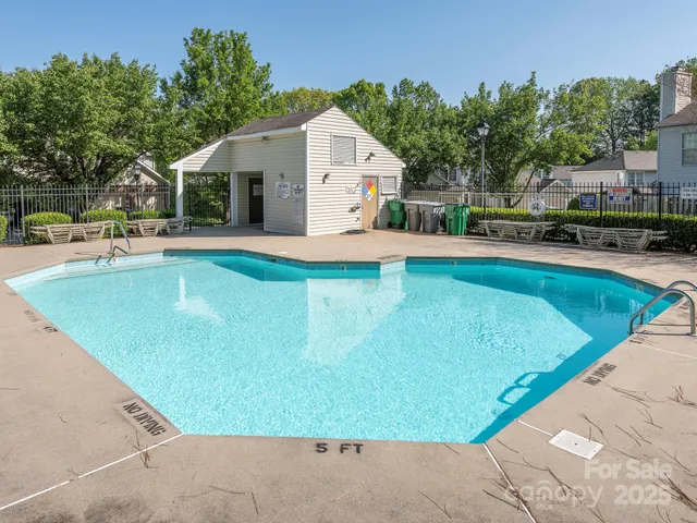 a view of a house with pool and chairs