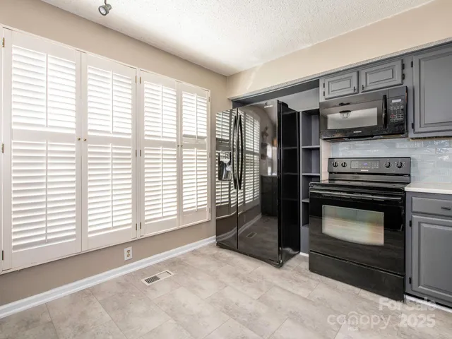 a kitchen with stainless steel appliances a stove and a refrigerator