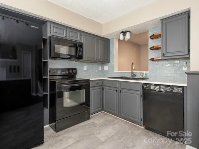 a kitchen with a sink stove and microwave
