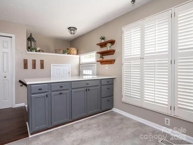 a kitchen with a window wooden cabinets and a window