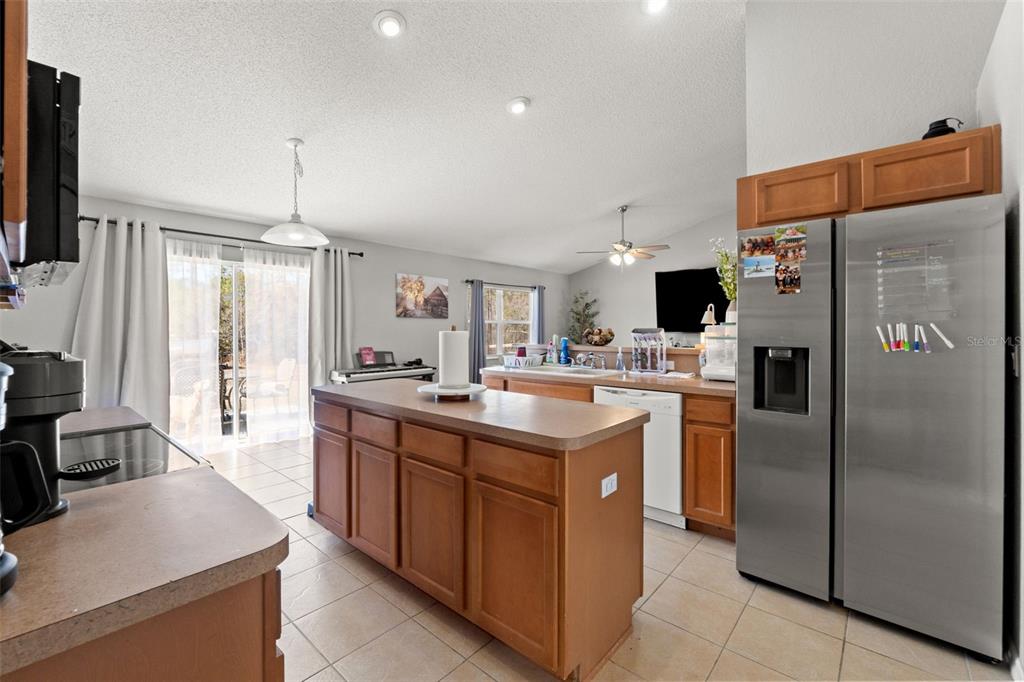 15335 Fleetwood Road Weeki Wachee, FL 34614 - Photo 25 of 40 a kitchen with stainless steel appliances granite countertop a refrigerator a sink a stove and a refrigerator
