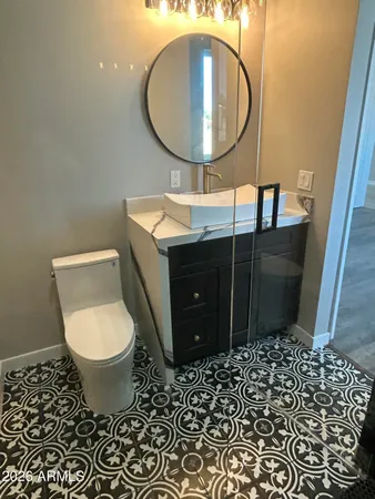 a bathroom with a toilet and a mirror