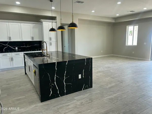 a kitchen with a refrigerator and a sink