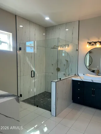 a bathroom with a double vanity sink mirror and shower