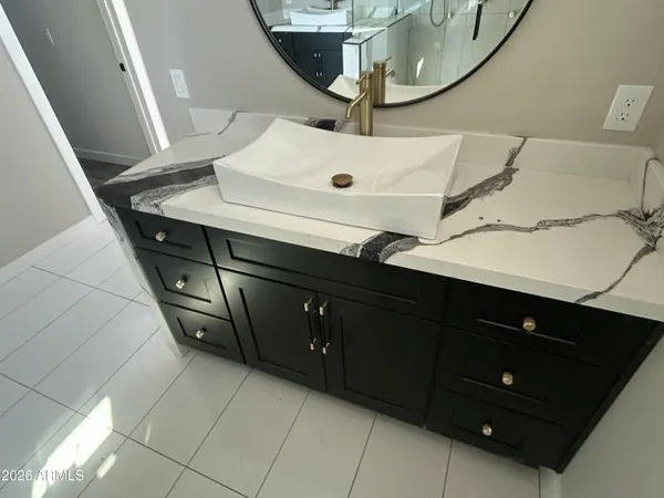 a bathroom with a sink vanity and mirror