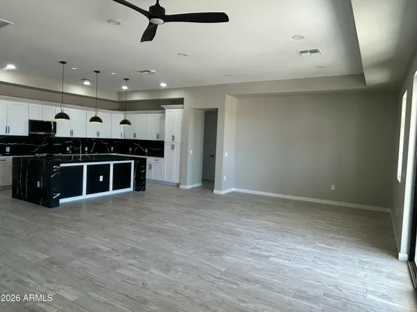 a view of a big room with furniture and kitchen view