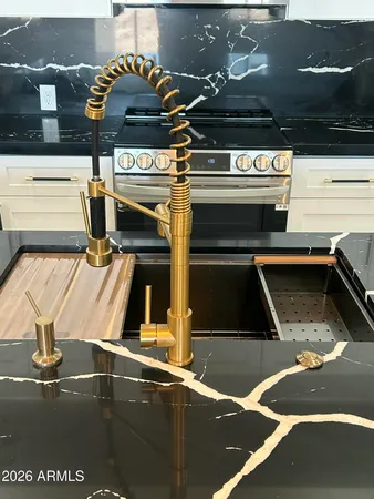 a kitchen with a sink a refrigerator and cabinets