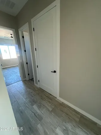 a view of a hallway with wooden floor and staircase