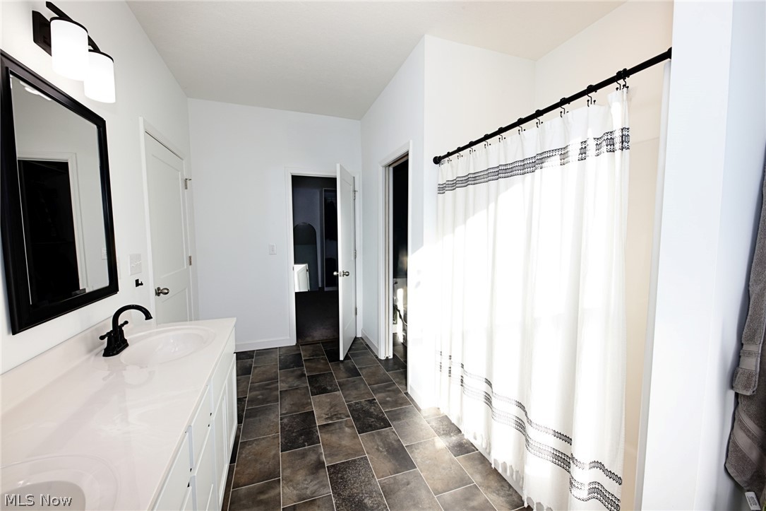 258 Friendly Acres Road Wellsburg, WV 26070 - Photo 21 of 47 Primary Bathroom with double vanity, a shower with shower curtain