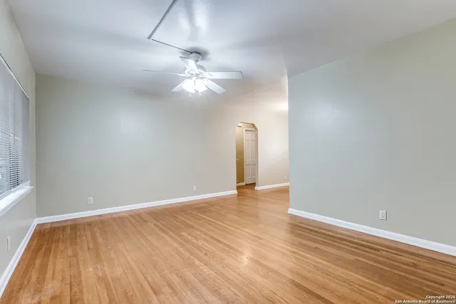 wooden floor in an empty room with a window