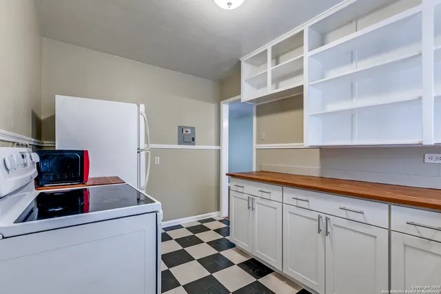 a kitchen with stainless steel appliances a sink and a refrigerator