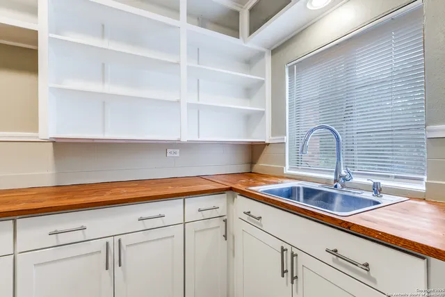 a kitchen with a sink and cabinets