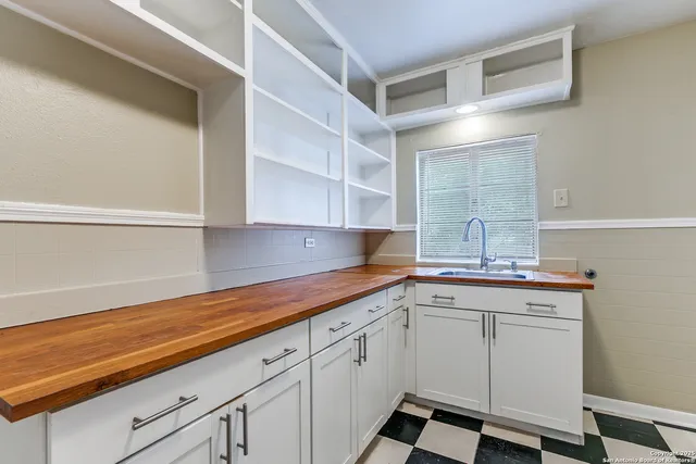 a kitchen with a sink cabinets and window