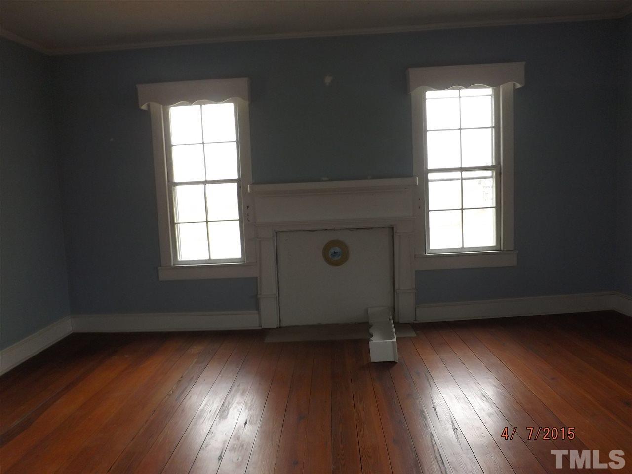 6119 Foushee Road Ramseur, NC 27316 - Photo 13 of 16 an empty room with wooden floor and windows
