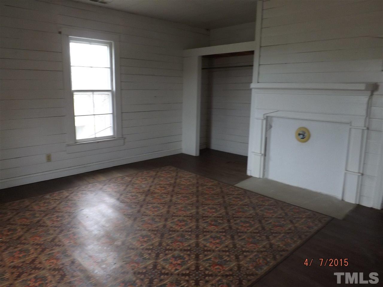 6119 Foushee Road Ramseur, NC 27316 - Photo 14 of 16 an empty room with wooden floor and windows