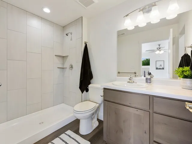 a bathroom with a sink toilet and shower