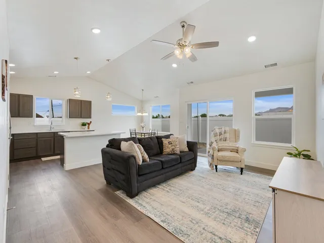 a living room with furniture and kitchen view