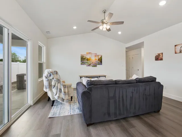 a living room with furniture and wooden floor