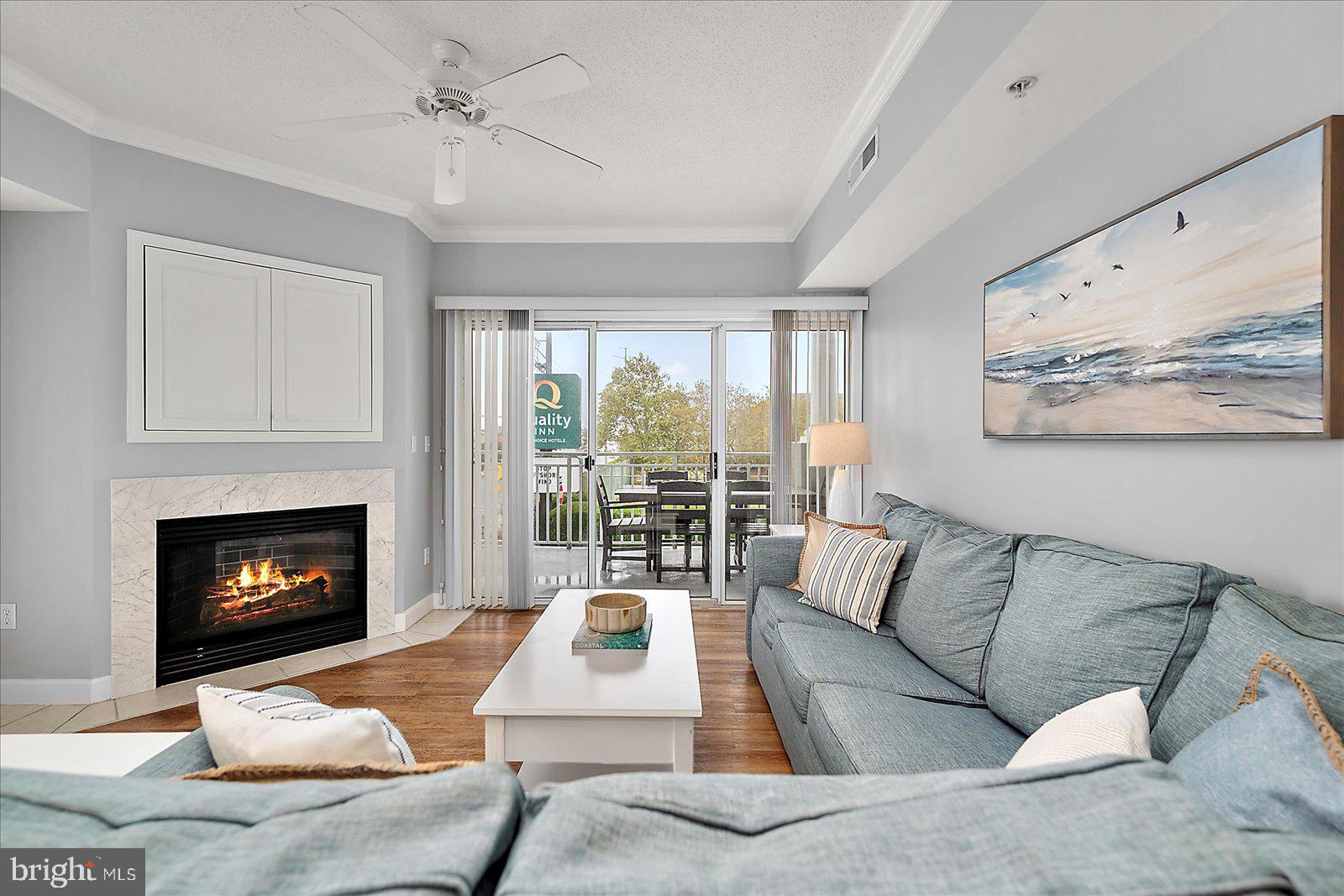 5300 Coastal Highway, Unit 101 Ocean City, MD 21842 - Photo 11 of 85 a living room with furniture and a fireplace