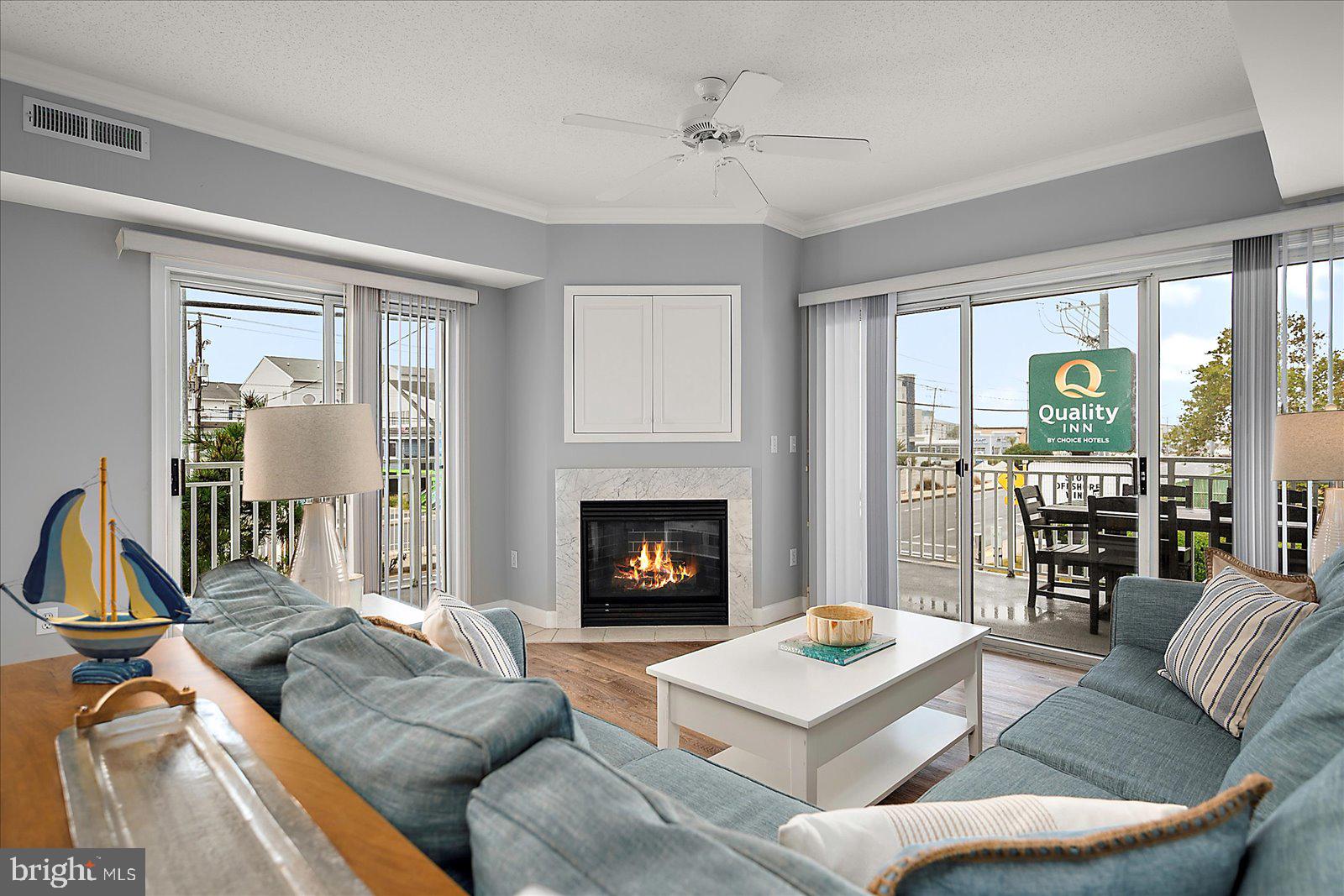 5300 Coastal Highway, Unit 101 Ocean City, MD 21842 - Photo 12 of 85 a living room with furniture and a fireplace