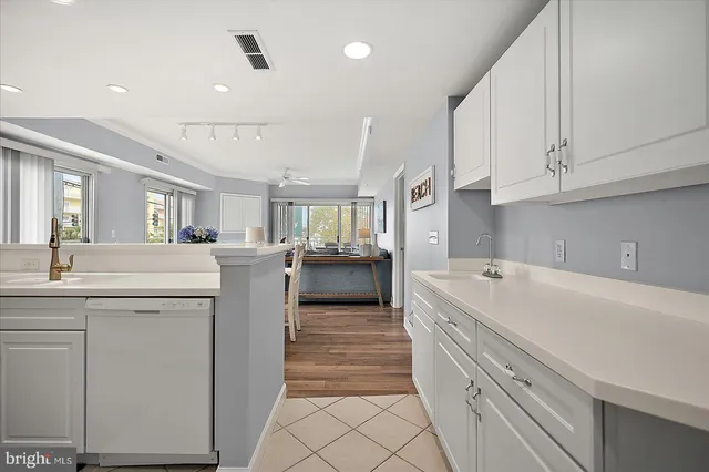 a kitchen with cabinets appliances and a sink