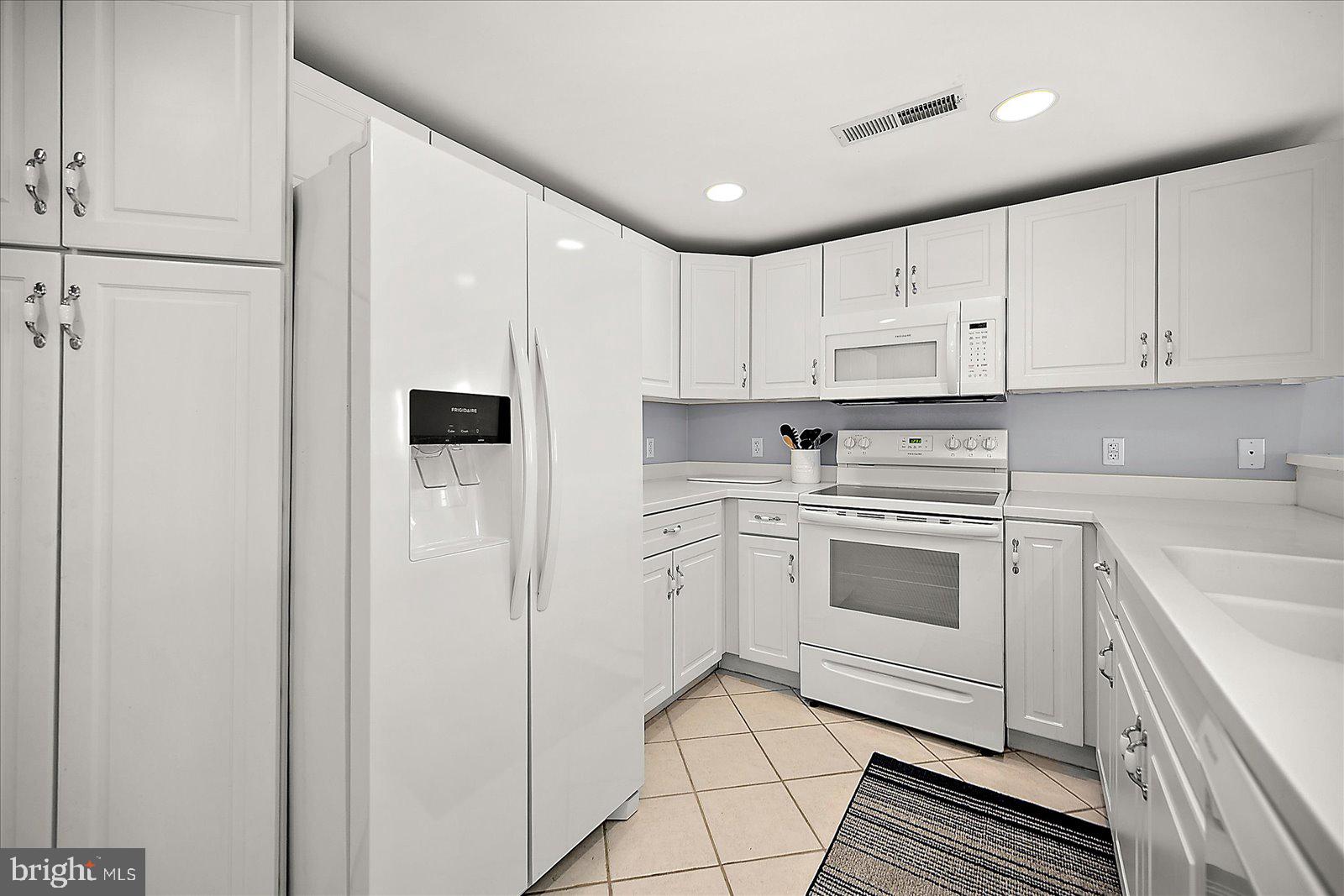 5300 Coastal Highway, Unit 101 Ocean City, MD 21842 - Photo 19 of 85 a kitchen with cabinets appliances and a sink