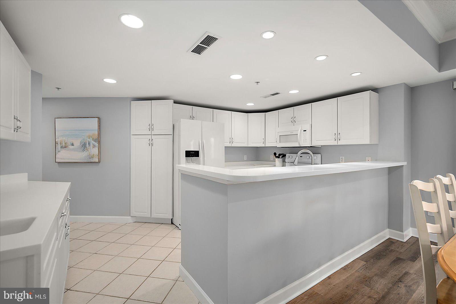 5300 Coastal Highway, Unit 101 Ocean City, MD 21842 - Photo 22 of 85 a view of kitchen with center island and stainless steel appliances