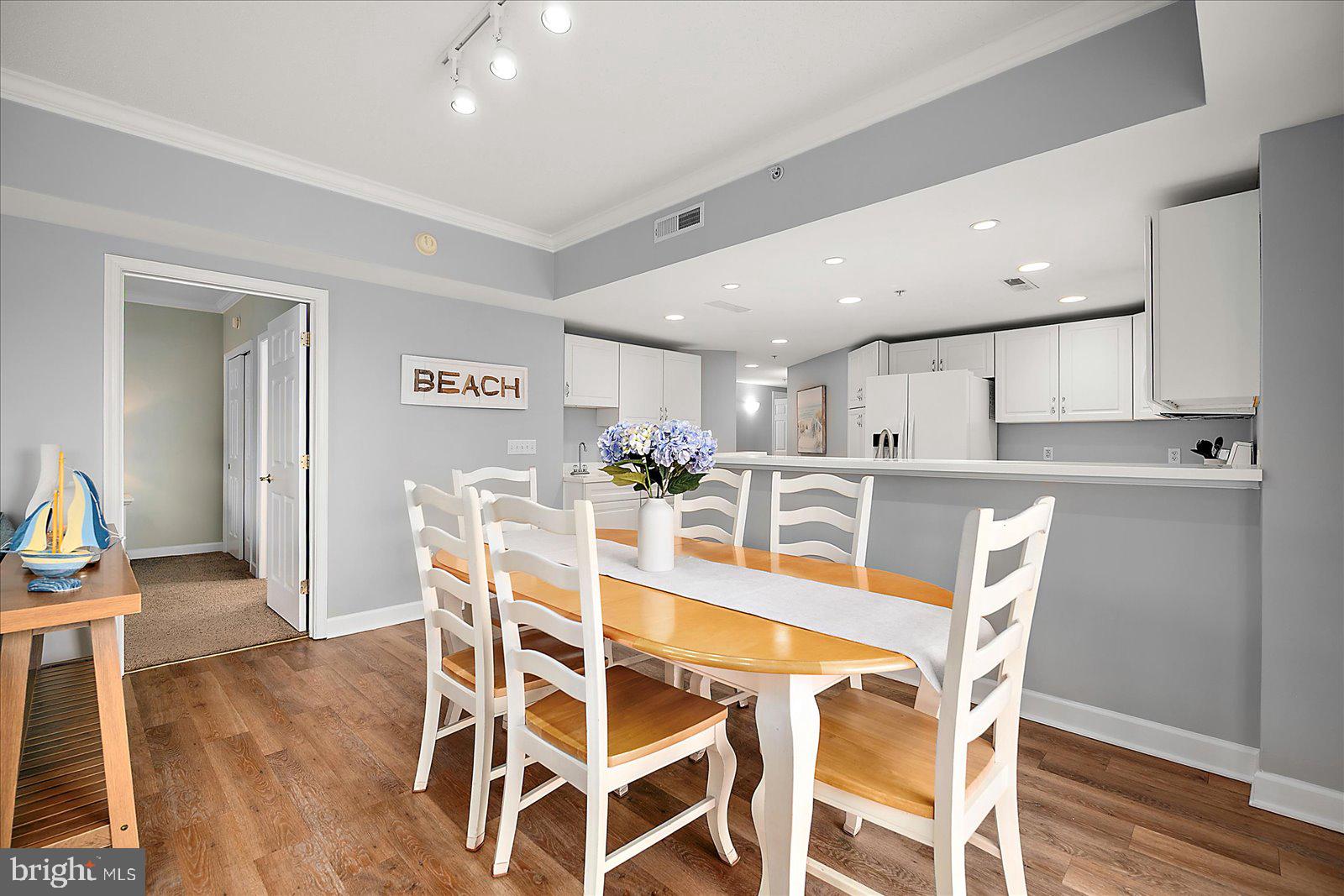 5300 Coastal Highway, Unit 101 Ocean City, MD 21842 - Photo 23 of 85 a dining room with furniture and wooden floor