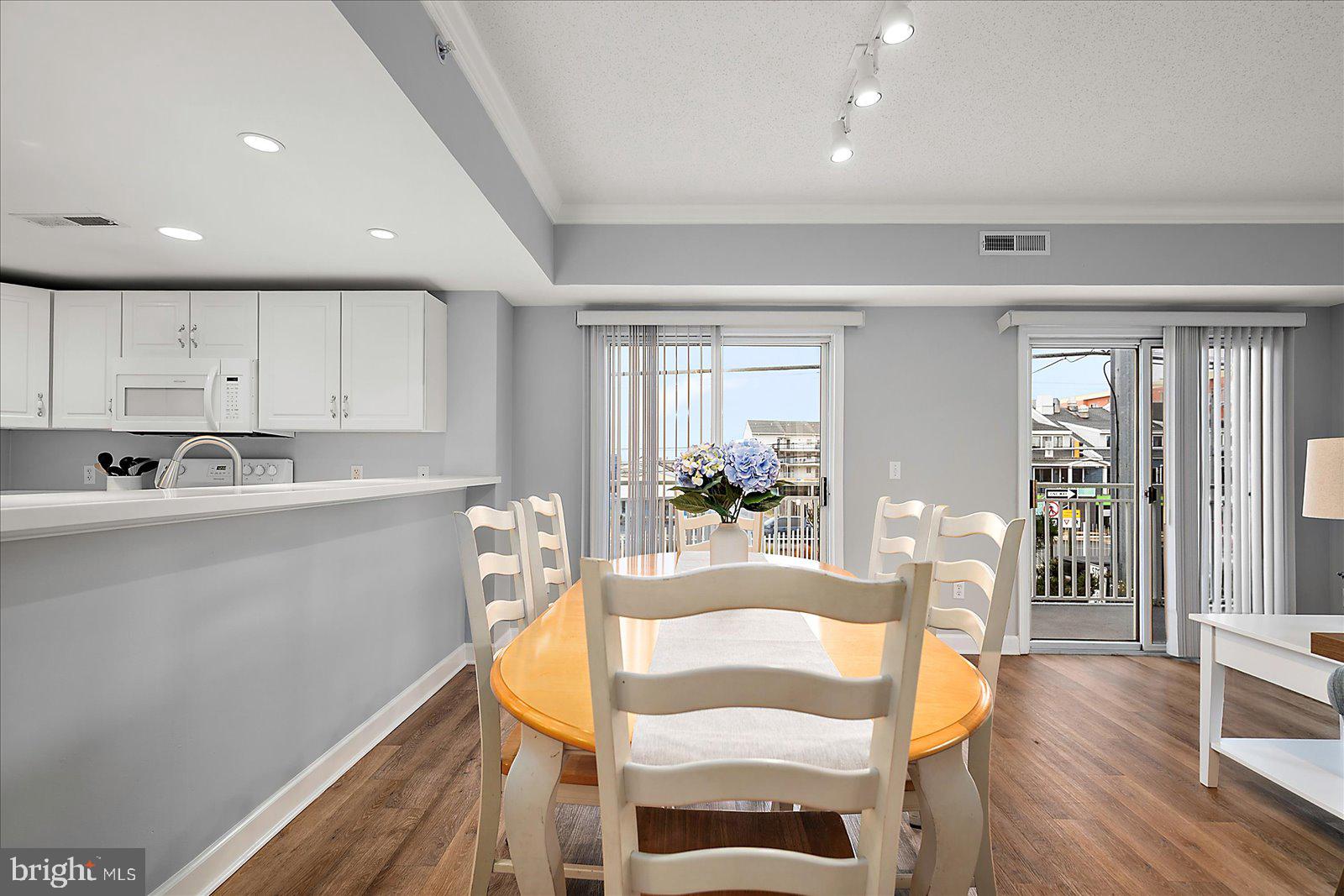 5300 Coastal Highway, Unit 101 Ocean City, MD 21842 - Photo 25 of 85 a view of a dining room with furniture and wooden floor