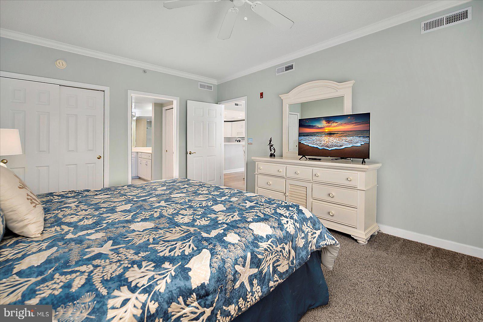 5300 Coastal Highway, Unit 101 Ocean City, MD 21842 - Photo 27 of 85 a bedroom with a bed and a flat screen tv