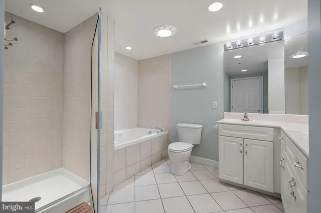 a bedroom with a bed and a mirror on dresser