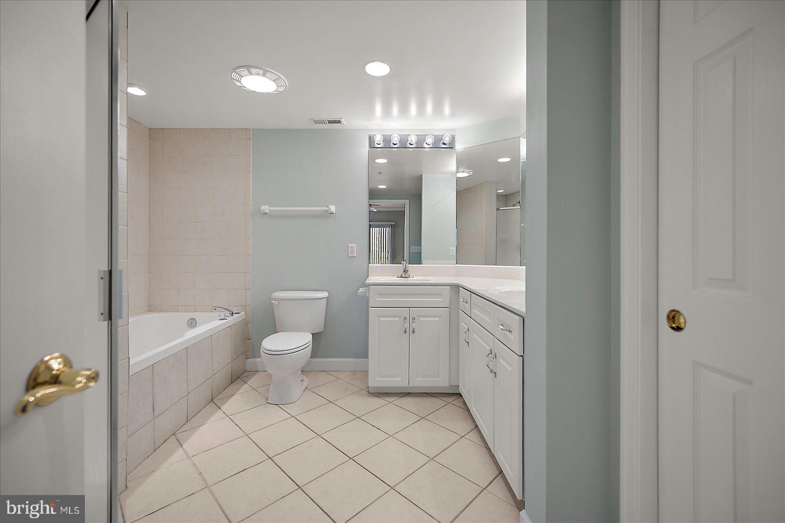 5300 Coastal Highway, Unit 101 Ocean City, MD 21842 - Photo 31 of 85 a bathroom with a double vanity sink a toilet and shower