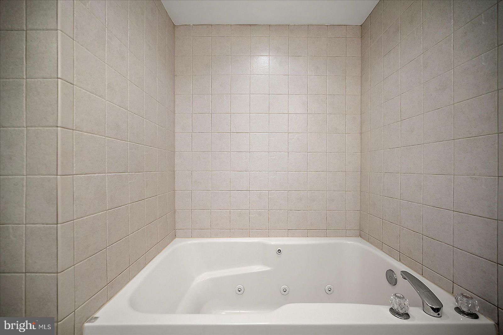 5300 Coastal Highway, Unit 101 Ocean City, MD 21842 - Photo 33 of 85 a bathroom with a bathtub