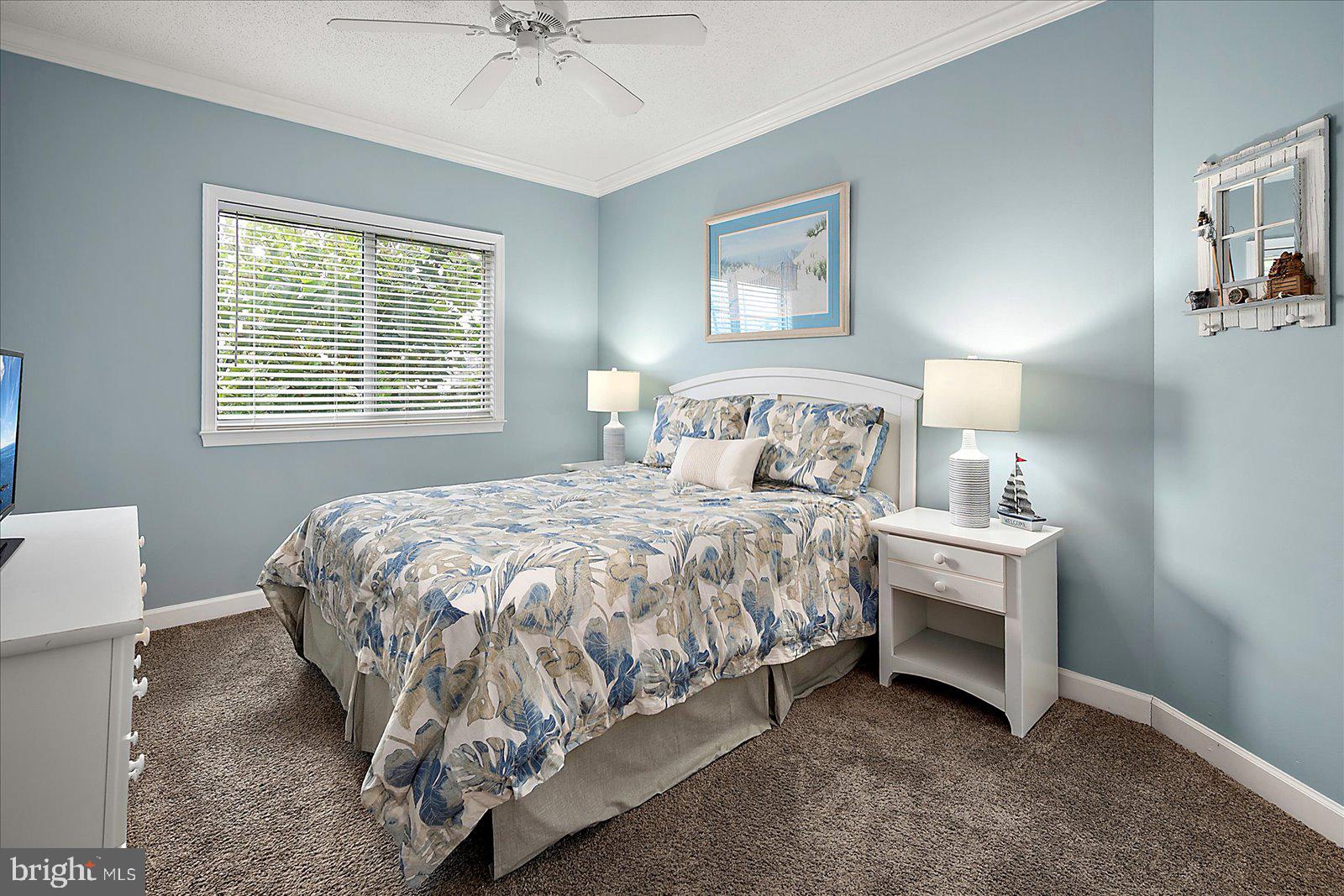 5300 Coastal Highway, Unit 101 Ocean City, MD 21842 - Photo 34 of 85 a bedroom with a bed and a table