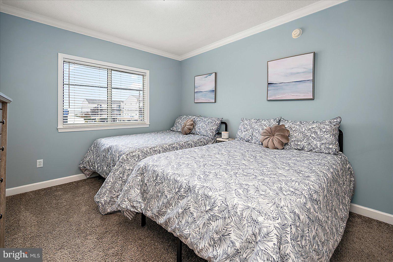 5300 Coastal Highway, Unit 101 Ocean City, MD 21842 - Photo 39 of 85 a bedroom with a bed and a window