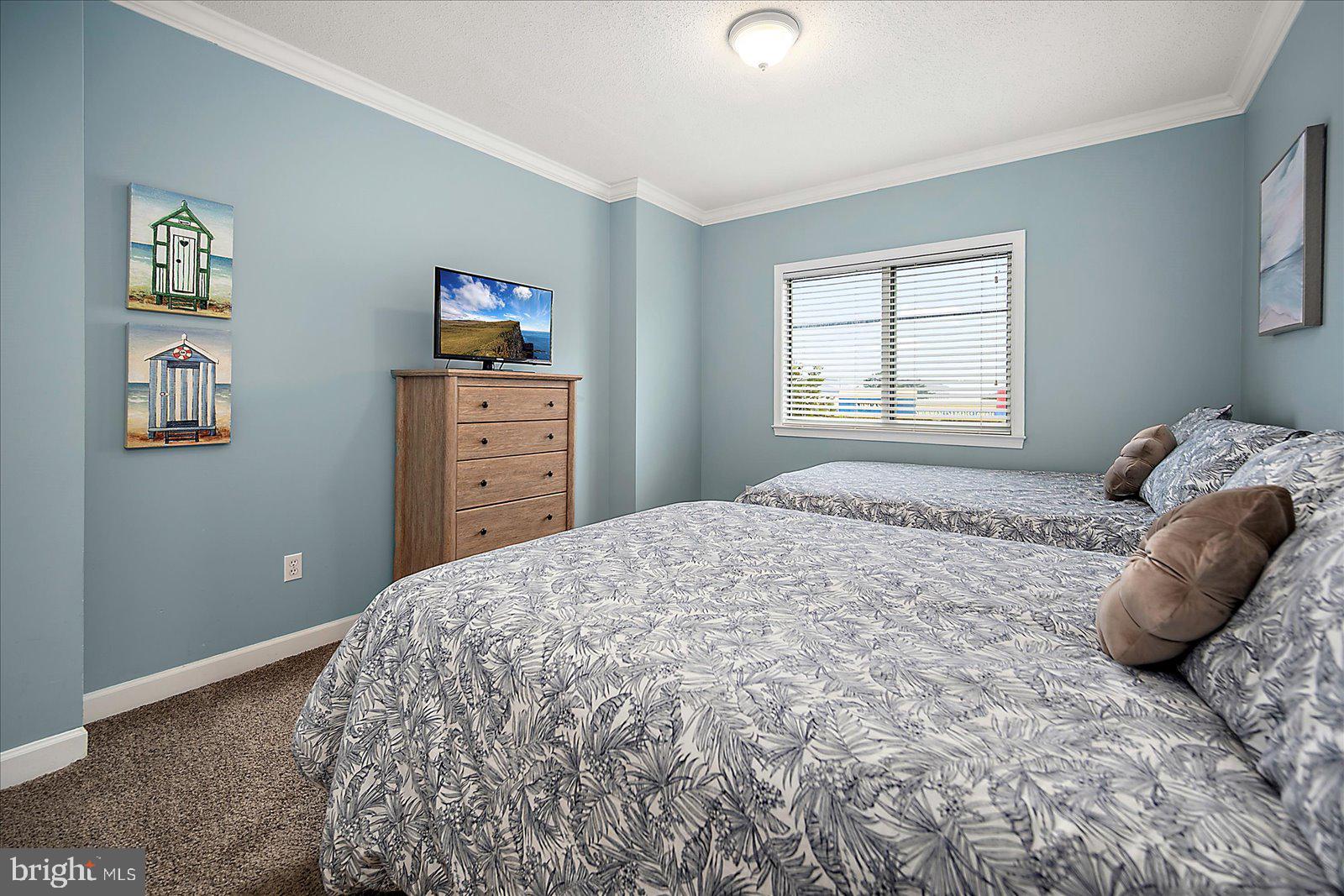5300 Coastal Highway, Unit 101 Ocean City, MD 21842 - Photo 40 of 85 a bedroom with a bed and a window