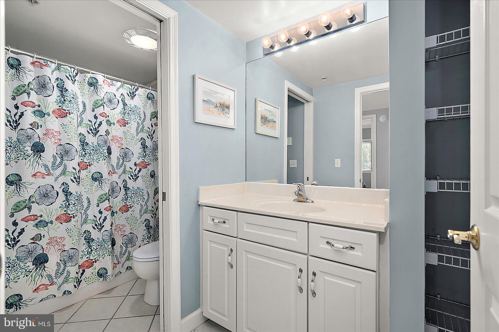 5300 Coastal Highway, Unit 101 Ocean City, MD 21842 - Photo 41 of 85 a bathroom with a sink and a mirror