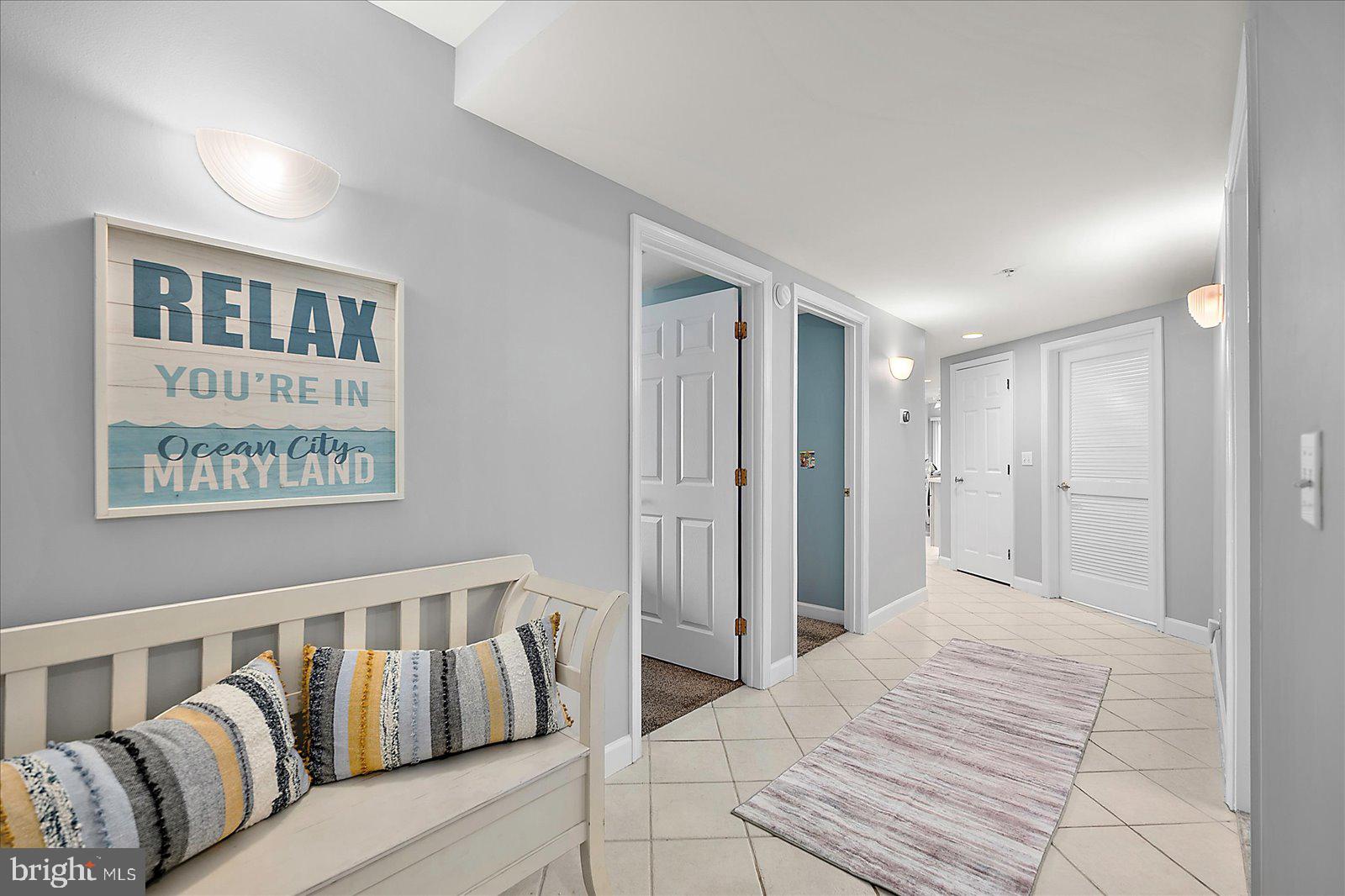 5300 Coastal Highway, Unit 101 Ocean City, MD 21842 - Photo 7 of 85 a bedroom with a large bed and a couch