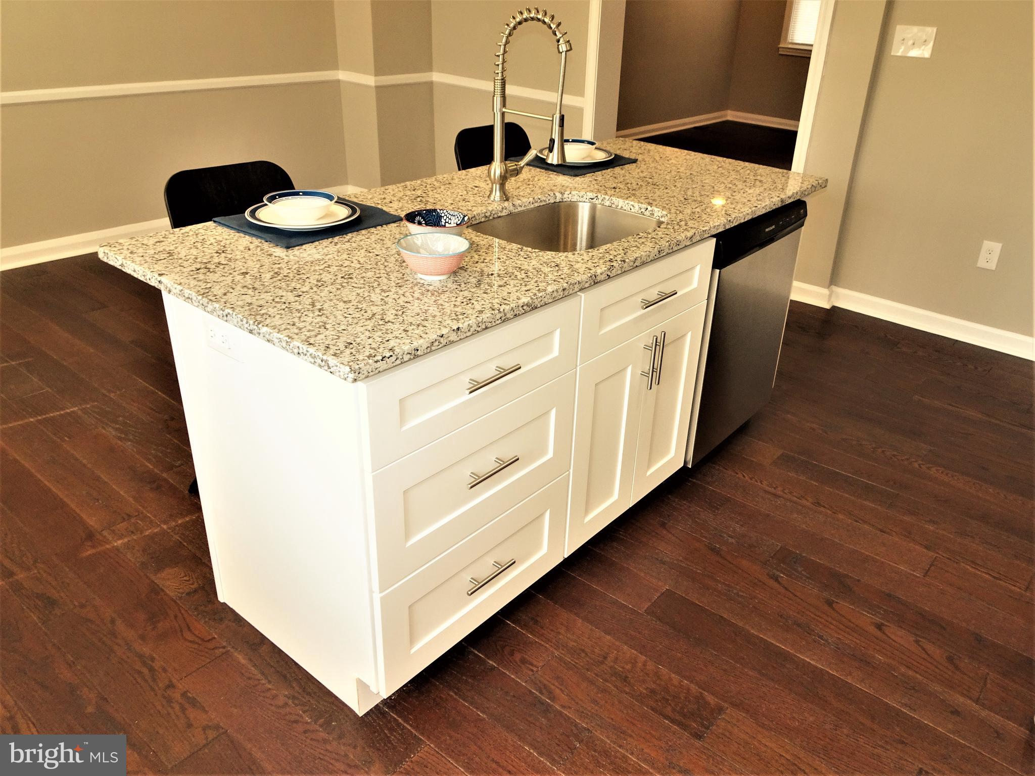 1217 Cedarcroft Road Baltimore, MD 21239 - Photo 10 of 46 Drawer cabinets and built in dishwasher in island