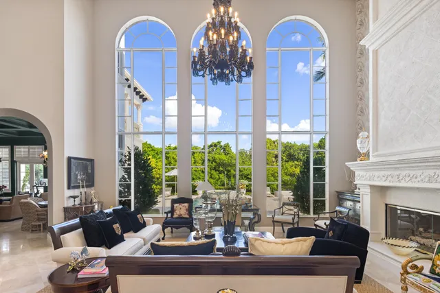 a view of a dining room with furniture a chandelier and wooden floor