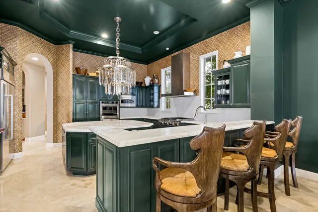 a kitchen that has a table and chairs in it