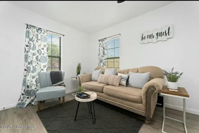 a living room with furniture and a large window