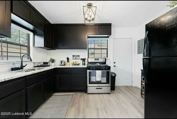 a kitchen with a sink appliances and cabinets