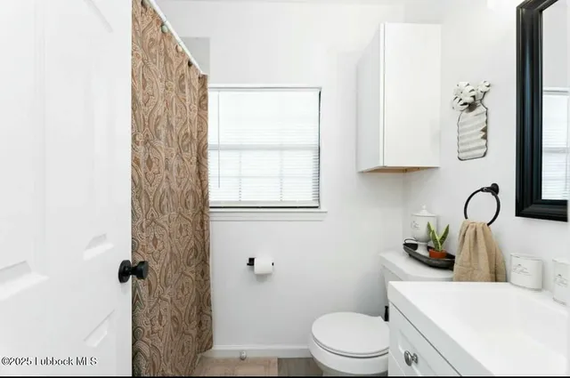 a white toilet sitting next to a bathroom sink