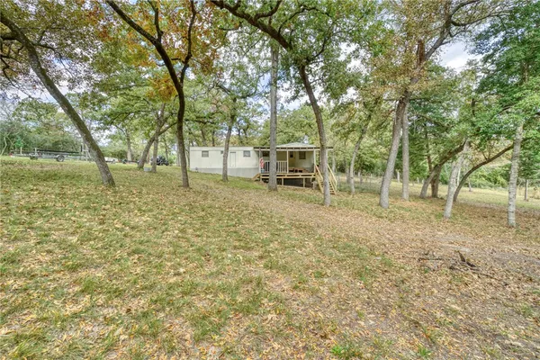 a backyard of a house with lots of trees